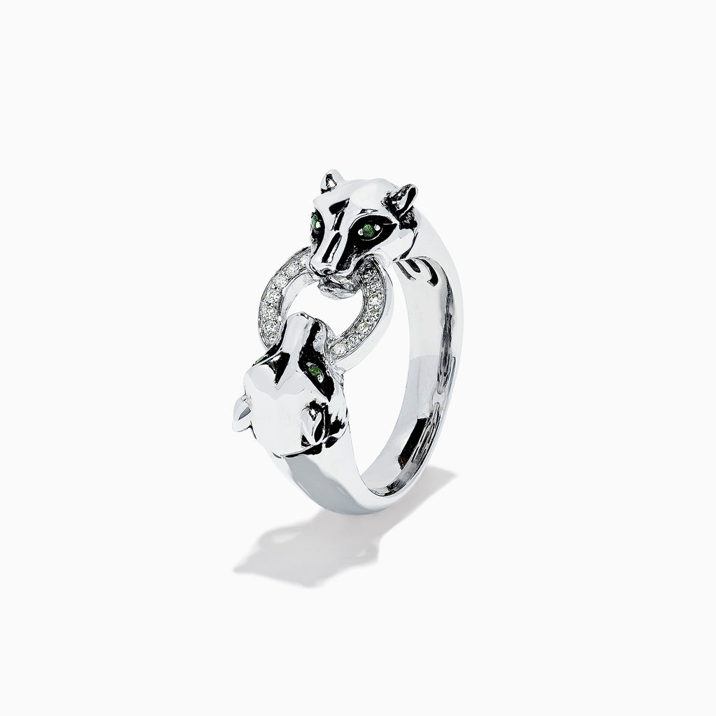 The Signature Sterling Silver Diamond Panther Ring, 0.09 TCW, features two panther heads with green gemstone eyes gripping a diamond-set circle in their mouths—an elegant and detailed design against a white backdrop.