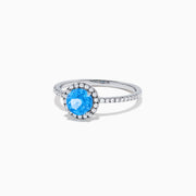 The Ocean Bleu 14K White Gold Blue Topaz and Diamond Ring, 1.12 TCW, showcases a round blue topaz center with a diamond halo and diamonds on the band.