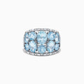 The Aquarius 14k White Gold Aquamarine and Diamond Ring showcases a wide band set with nine oval-cut aquamarines in three rows, accented by sparkling diamonds along the edges for added brilliance.
