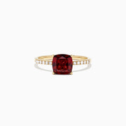 The Bordeaux 14K Yellow Gold Garnet and Diamond Ring (1.66 TCW) features a cushion-cut deep red garnet centerpiece with round white diamonds set along the band.