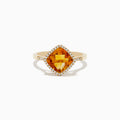 The Sunset 14K Yellow Gold Citrine and Diamond Ring features a cushion-cut citrine center stone encircled by a halo of sparkling white diamonds, displayed on a white background.
