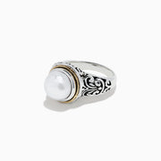The 925 Sterling Silver and 18K Gold Fresh Water Pearl Ring features a large round freshwater pearl centerpiece, set in ornate sterling silver with a delicate 18K gold band accent.