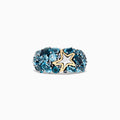 The Seaside Silver and 18K Gold Blue Topaz Starfish Ring, 6.70 TCW, features clusters of oval blue topaz stones set in silver with a gold-outlined starfish accent at the center, shown on a white background.