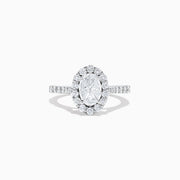 The 14K White Gold Diamond Ring and Matching Band Set, 2.00 TCW, features a large oval center diamond with a halo of round diamonds and a diamond-studded band—displayed against white, ideal for elegant bridal sets.