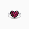 The 925 Sterling Silver Ruby Heart Ring, 1.02 TCW, showcases a heart-shaped centerpiece adorned with sparkling red stones set in silver against a white backdrop.
