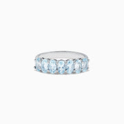 The Aquarius Sterling Silver Aquamarine Ring, 1.50 TCW, features a row of seven elongated oval light blue gemstones and is showcased on a plain white background.
