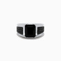 The Mens 925 Sterling Silver Onyx and Black Spinel Ring features a large rectangular black onyx centerpiece, accented by small round black spinel stones set along each side of the band, displayed on a white background.