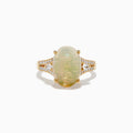 The Aurora 14K Yellow Gold Diamond and Opal Ring showcases a large oval opal center, accented by rows of sparkling diamonds on each side, all set in polished yellow gold.