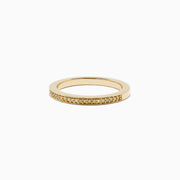 An 18K yellow gold half eternity band ring, featuring 0.13 TCW of sparkling yellow diamonds, is displayed against a plain white background.