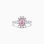 A GIA certified faint pink diamond ring, 1.53 TCW, set in a halo of round white diamonds on an 18K two tone gold band. Shown on a plain white background.