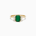 The Brasilica 14K Yellow Gold Emerald and Diamond Ring (1.57 TCW) showcases a rectangular emerald center, accented by round white diamonds on each side, set against a white background.