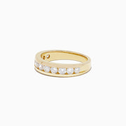 The DOro 14K Yellow Gold Channel Set Diamond Band, 0.98 TCW, showcases round-cut diamonds set in a sleek channel design and is elegantly presented on a plain white background.