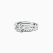 A beautiful Bridal 14K White Gold Diamond Cluster Ring and Band Set, 0.72 TCW, featuring a round central diamond, surrounded by smaller diamonds on a split shank for extra sparkle.