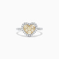 The Canare 14K Two Tone Gold Heart Shaped Yellow Diamond Heart Ring (0.77 TCW) features clustered yellow diamonds at the center, a halo of white diamonds, and a diamond-encrusted two tone gold band, shown on a white background.