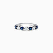 The Royale Bleu 14K White Gold Blue Sapphire and Diamond Ring (0.96 TCW) showcases alternating round blue sapphires and white diamonds set in a row along the band, displayed on a white background.