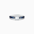 The Royale Bleu 14K White Gold Sapphire and Diamond Ring features a rectangular emerald-cut diamond centerpiece with round blue sapphires along the band, creating an elegant and symmetrical look. Shown photographed on a white background.