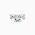 The Pave Classica 14K White Gold Diamond Ring features a round center diamond, double halo of smaller diamonds, and a split shank band with sparkling stones, beautifully displayed on a white background.