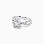 The Pave Classica 14K White Gold Diamond Ring features a round center diamond, double halo of smaller diamonds, and a split shank band with sparkling stones, beautifully displayed on a white background.