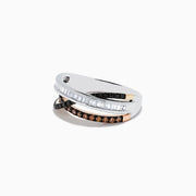 The 14K Three-Tone Gold Brown, Black and White Diamond Crossover Ring (0.63 TCW) features rows of baguette white, round black, and round brown diamonds elegantly crisscrossing on a lustrous gold band.