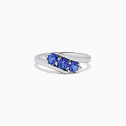 The Nahla Siri Sterling Silver Tanzanite and Diamond Ring (0.86 TCW) showcases three round tanzanites set side by side in a modern overlapping band, displayed on a white background.