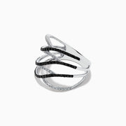 The 14K White Gold White and Black Diamond Crossover Ring features wide, wavy open bands with alternating black and white diamonds in an elegant intertwined pattern.