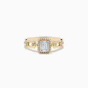 The Doro 14K Yellow Gold Diamond Ring showcases a rectangular baguette-cut center diamond, a halo of round diamonds, and extra small diamonds set along its split band.