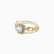 The Doro 14K Yellow Gold Diamond Ring showcases a rectangular baguette-cut center diamond, a halo of round diamonds, and extra small diamonds set along its split band.