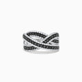 The 14K White Gold Black and White Diamond Crossover Ring features intertwining bands set with rows of black and white diamonds, creating a striking, braided design.