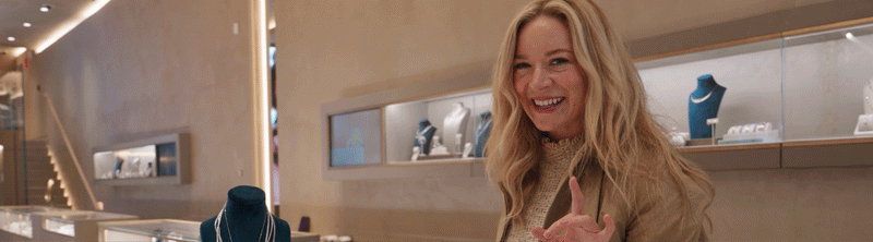 A satin blue ribbon with the words Erin Walsh’s Ultimate Holiday Gift Guide written in white text across the center.