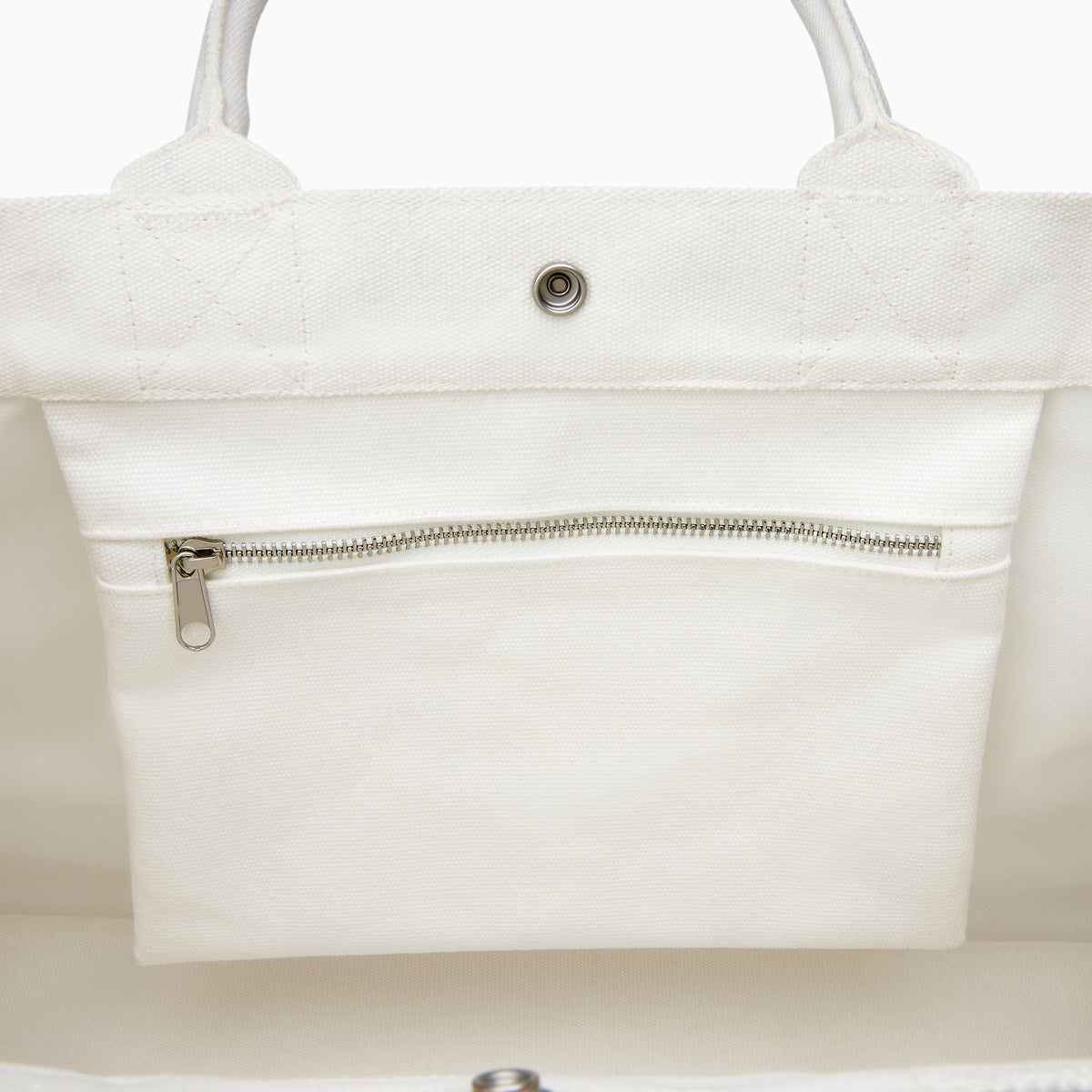 The Beach Bag - White is a large canvas tote with two handles, featuring blue and turquoise tassels and EAFY printed in black near the bottom right corner.