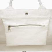The Beach Bag - White is a large canvas tote with two handles, featuring blue and turquoise tassels and EAFY printed in black near the bottom right corner.