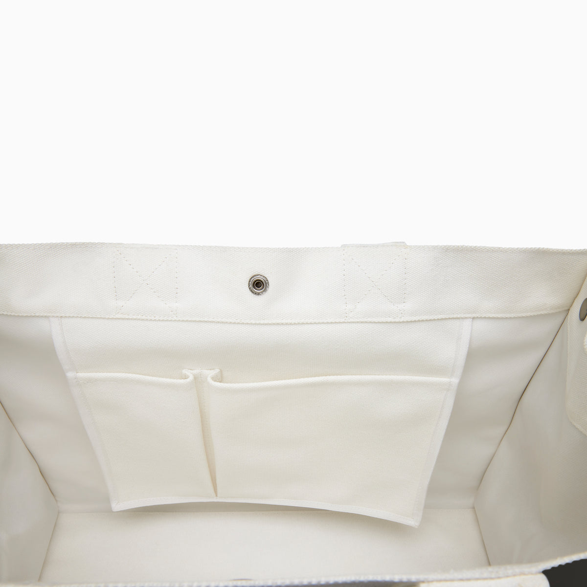 The Beach Bag - White is a large canvas tote with two handles, featuring blue and turquoise tassels and EAFY printed in black near the bottom right corner.
