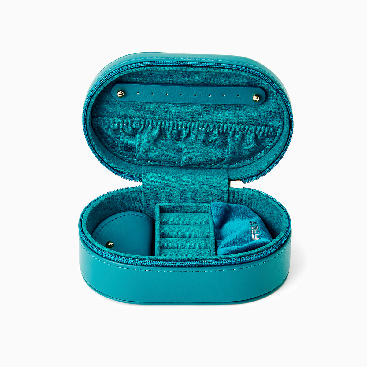 The Effy Oval Travel Case is a small, oval-shaped zippered case in teal vegan leather with a matching teal zipper, closed and displayed on a white background.