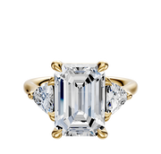 The 14K Yellow Gold 3-Stone Trillion Side Stones 0.25TCW Engagement Ring features a central diamond with two side-set trillion-cut diamonds, shown on a white background.