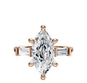The 14K Rose Gold 3-Stone Baguette East/West Side Stones 0.125TCW Engagement Ring features a marquise-cut center stone secured by six prongs, flanked by baguette side stones on a rose gold band, displayed on a white background.