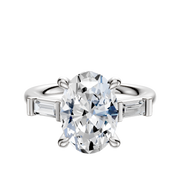 The 14K White Gold 3-Stone Baguette East/West Side Stones 0.125TCW Engagement Ring showcases a central diamond with two baguette-cut side stones, elegantly displayed against a plain white background.