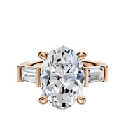 The 18K Rose Gold 3-Stone Baguette East/West Side Stones 0.25TCW Engagement Ring features a central diamond and two baguette-cut side stones, shown on a plain white background.