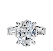 The Platinum 3-Stone Baguette East/West Side Stones 0.25TCW Engagement Ring showcases a central oval-cut diamond with two baguette side stones, displayed on a plain white background.
