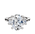A 14K white gold engagement ring featuring a three-stone design with an oval center and side stones totaling 0.125TCW.