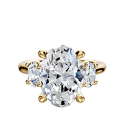 The 14K Yellow Gold 3-Stone Oval Side Stones 0.25TCW Engagement Ring features a central oval diamond and two smaller oval side stones, all set in yellow gold prongs.