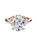 A 14K rose gold engagement ring featuring a large center diamond with three-stone design and pear-shaped side stones (0.125 TCW), shown against a plain white background.
