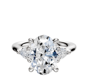 A 14K white gold engagement ring featuring a center stone with three-stone design and 0.125 TCW pear side stones, displayed against a plain white background.