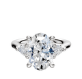 A dazzling 18K White Gold engagement ring featuring a large center stone and two pear-shaped side stones (0.125TCW), showcased against a plain white background.
