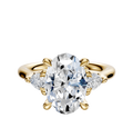A 14K yellow gold engagement ring with a center stone and two pear-shaped side stones, totaling 0.125 carats, in a classic three-stone setting.