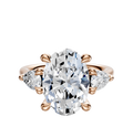 The 18K Rose Gold 3-Stone Pear Side Stones 0.25TCW Engagement Ring features a large oval diamond center with two pear-shaped side stones, all set against a plain white background.