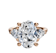 The 14K Rose Gold 3-Stone Trillion Side Stones 0.25TCW Engagement Ring features a central diamond secured by four prongs and two sparkling trillion side stones, all set on an elegant rose gold band.