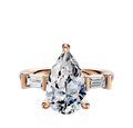 The 14K Rose Gold 3-Stone Baguette East/West Side Stones 0.125TCW Engagement Ring showcases a central stone with rectangular baguette side accents, all set against a plain white background.