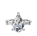 A 14K white gold engagement ring with a three-stone design, featuring east/west baguette side stones totaling 0.125TCW, displayed against a plain white background.