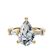 The 18K Yellow Gold 3-Stone Baguette East/West Side Stones 0.125TCW Engagement Ring features a central diamond with two baguette-cut side stones, showcased on a plain white background.