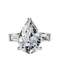 The Platinum 3-Stone Baguette East/West Side Stones 0.25TCW Engagement Ring showcases a pear-shaped diamond center with two tapered baguette-cut side stones, beautifully displayed against a plain white background.